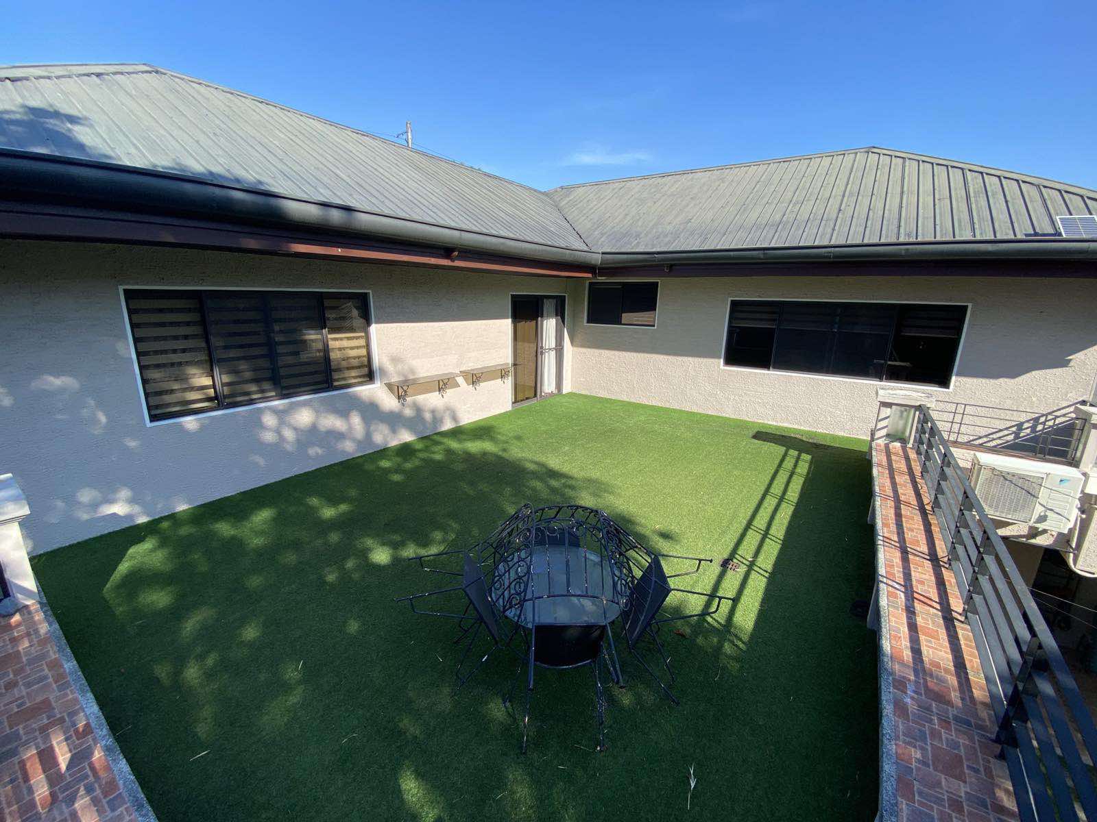 Interior courtyard lawn framed by the home's wings