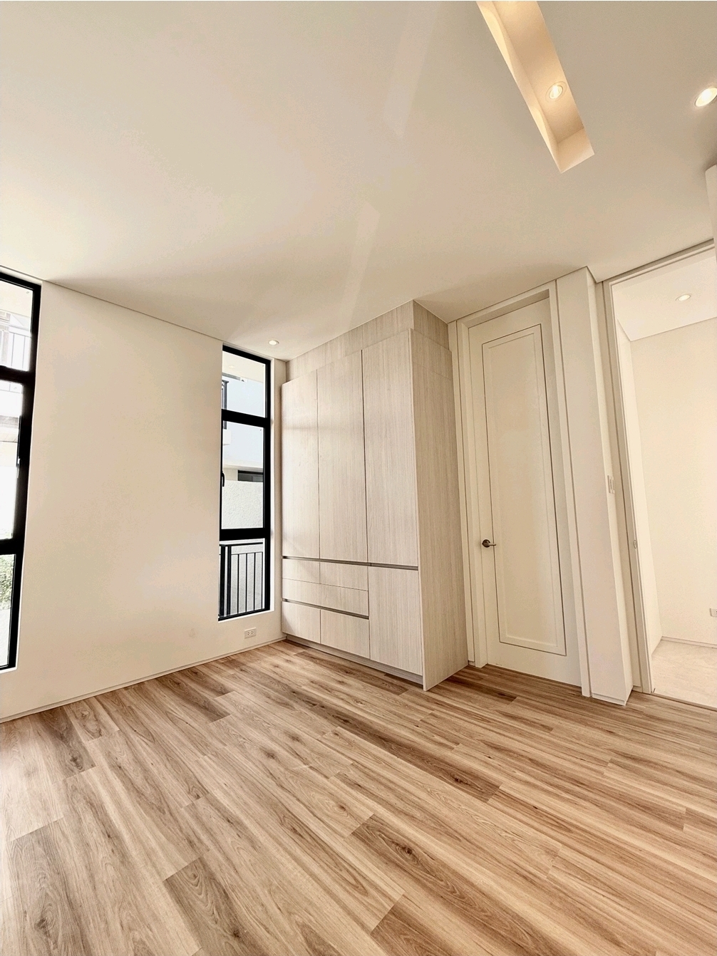 Master bedroom with built-in cabinetry and walk-in closet