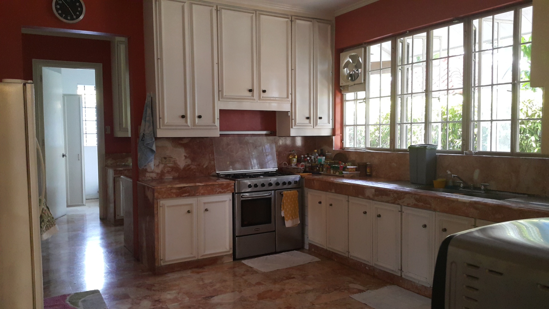 Kitchen with marble counters, range, and service entry