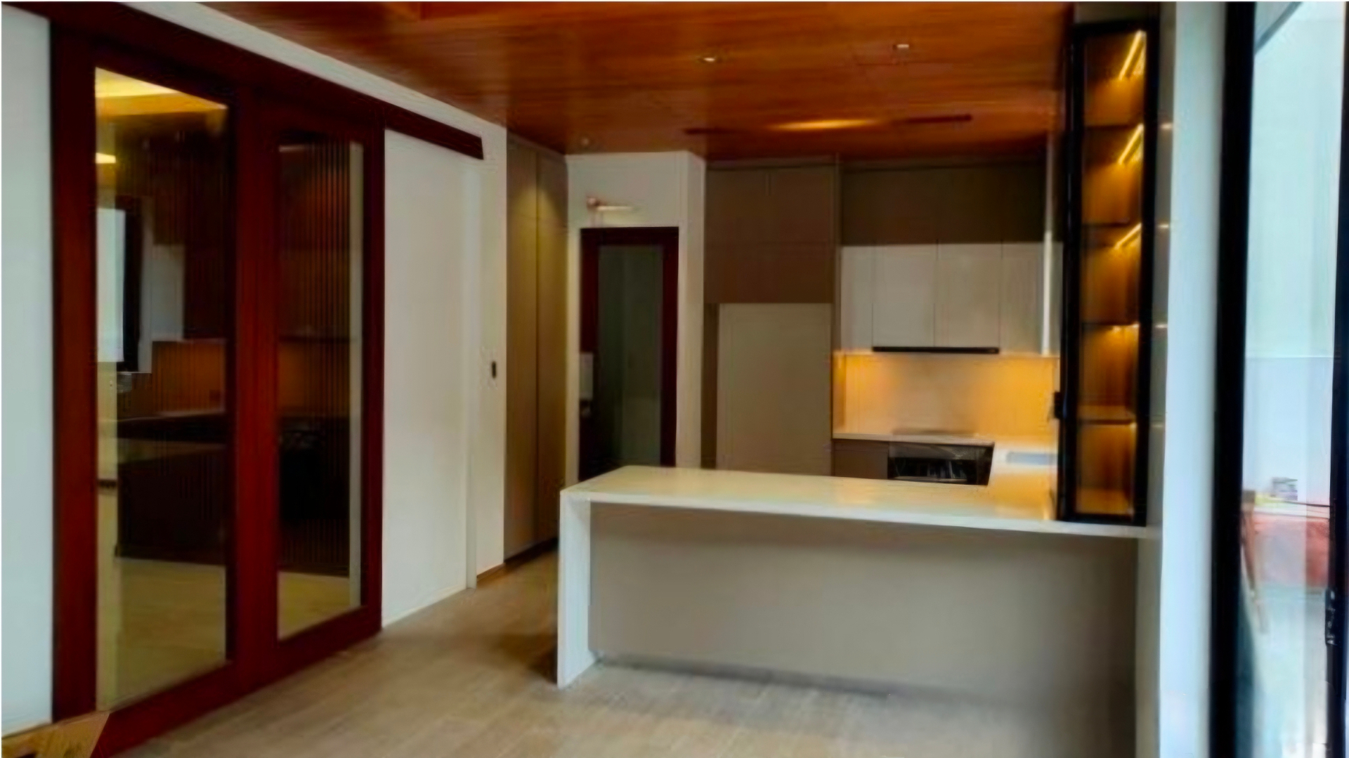 Modular kitchen with breakfast counter and lit display niches