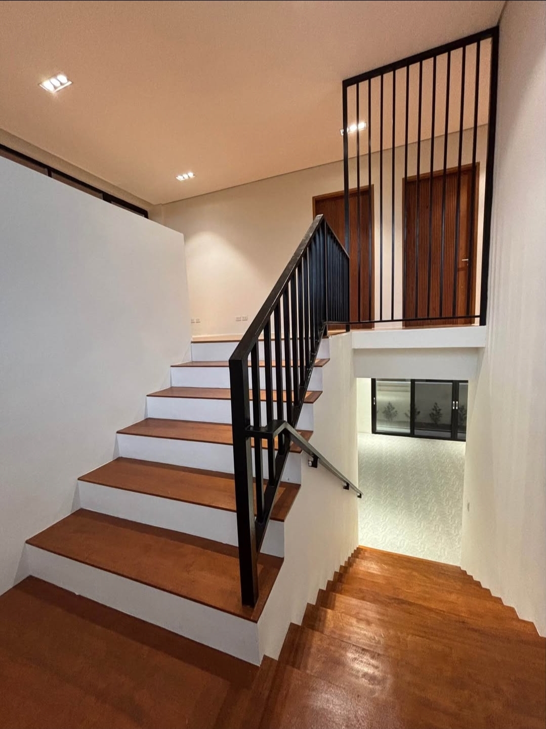 Timber staircase with black steel balustrade and upper landing