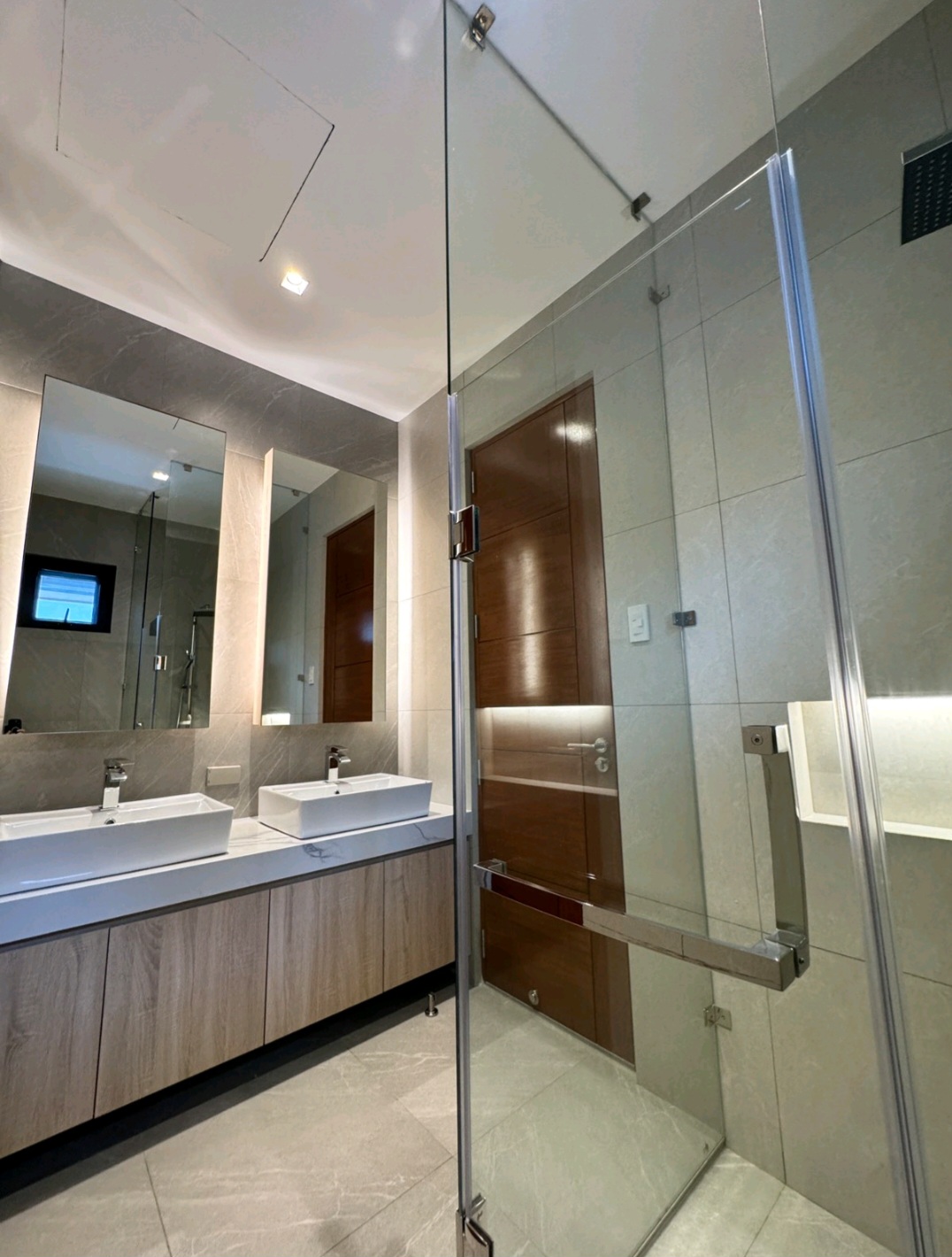 Second bath with double vanity, backlit mirror, and rain shower