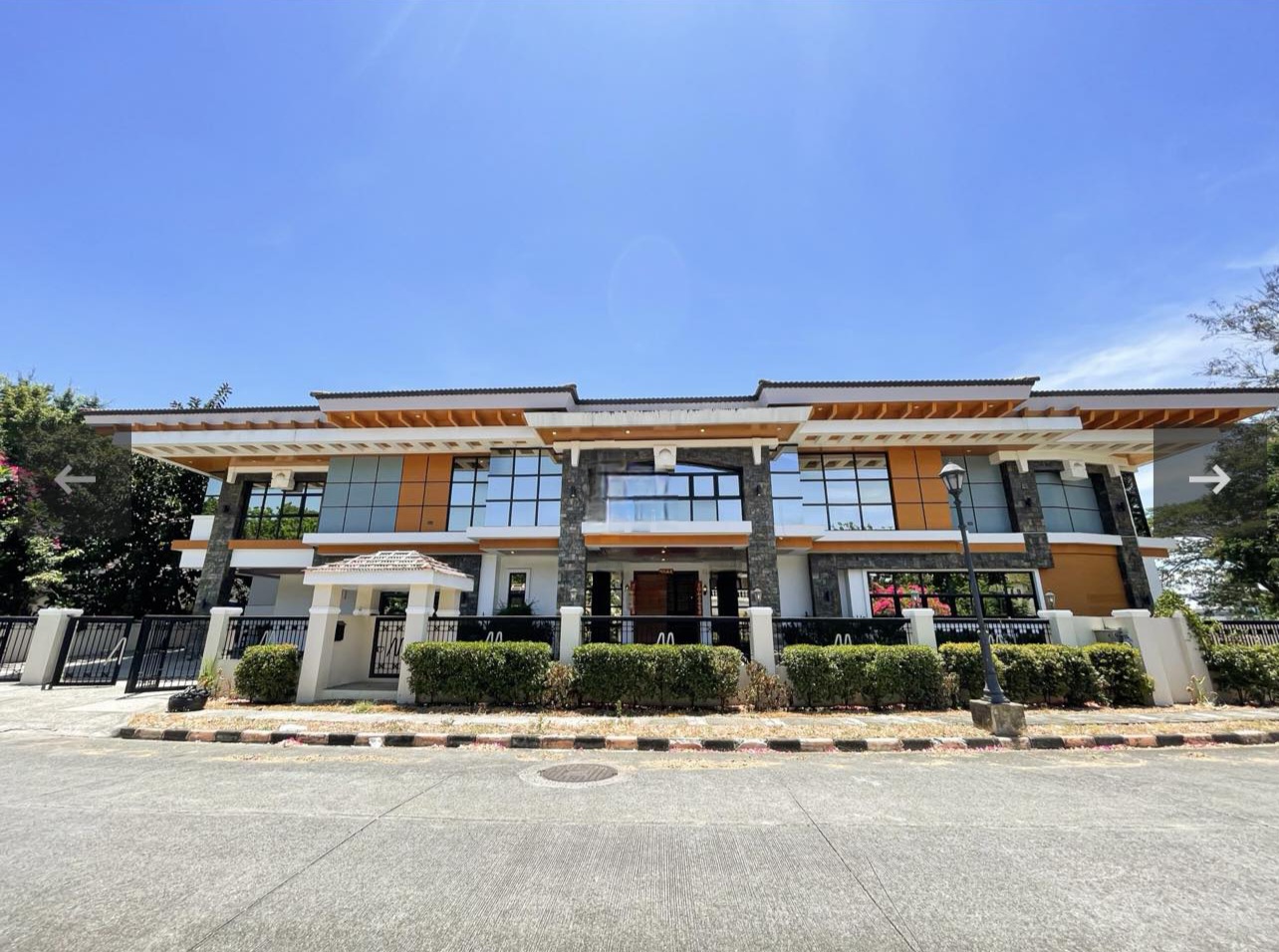 Two-storey Brentville International villa facade with stone and wood accents