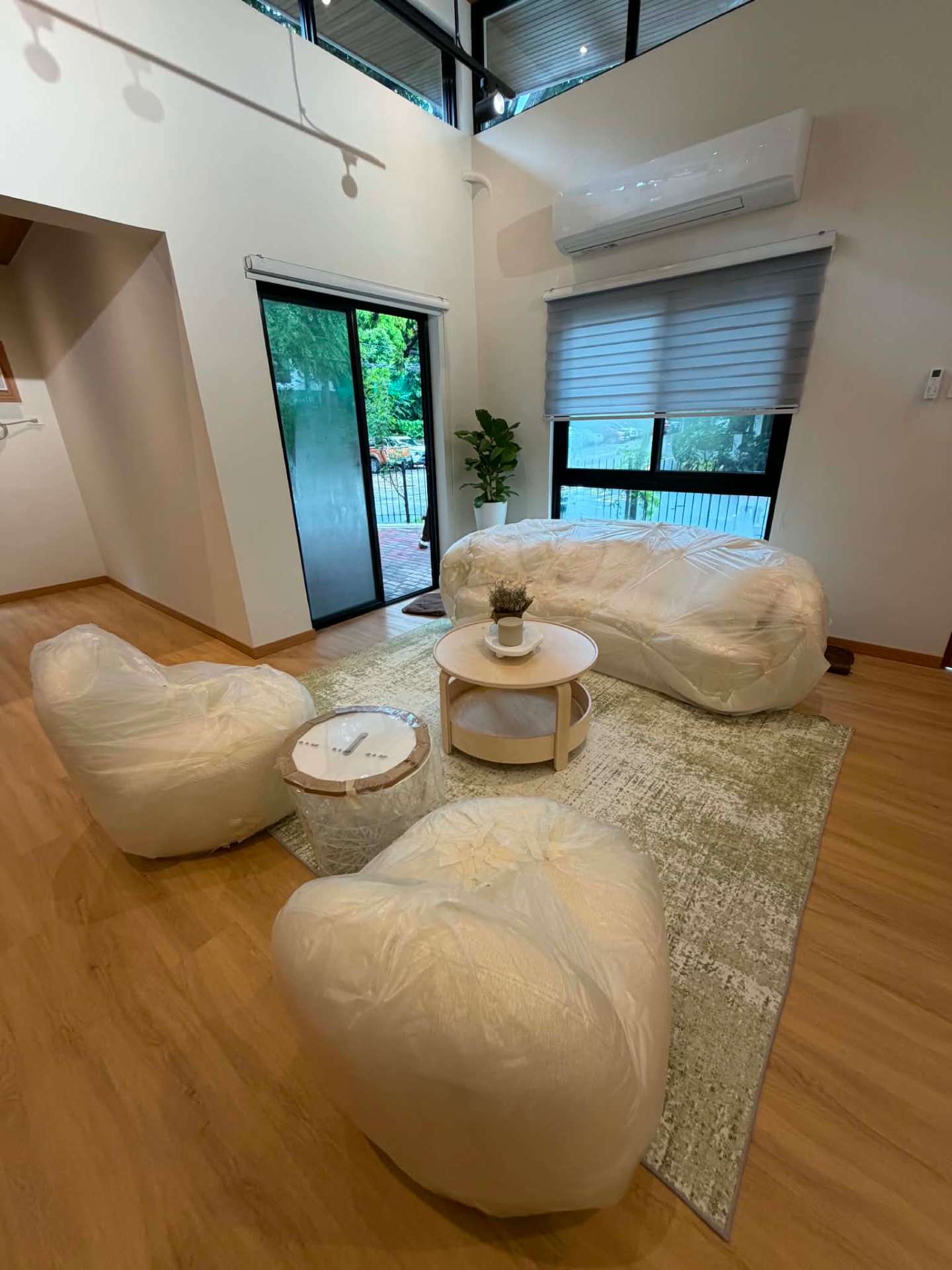 Double-height lounge with sliding glass doors to the garden and clerestory glazing above