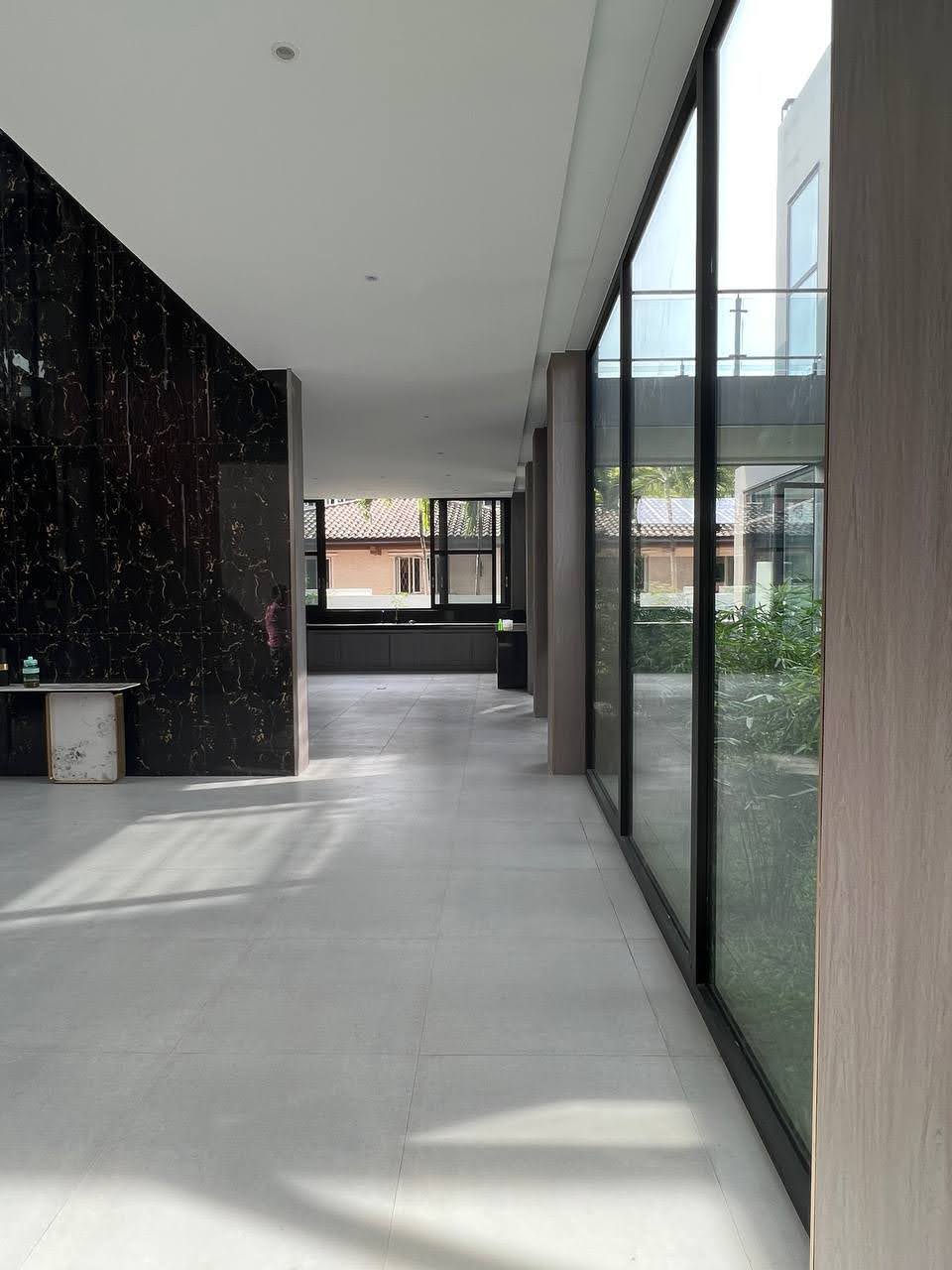 Marble-clad corridor with floor-to-ceiling glass