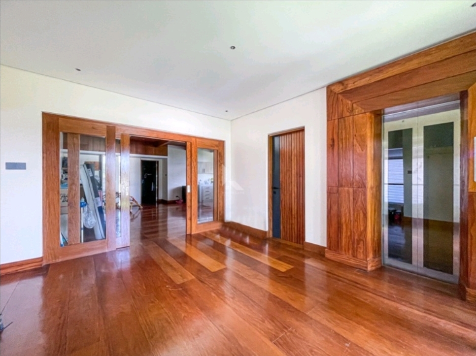 Landing with hardwood-framed elevator lobby and wide sliding doors