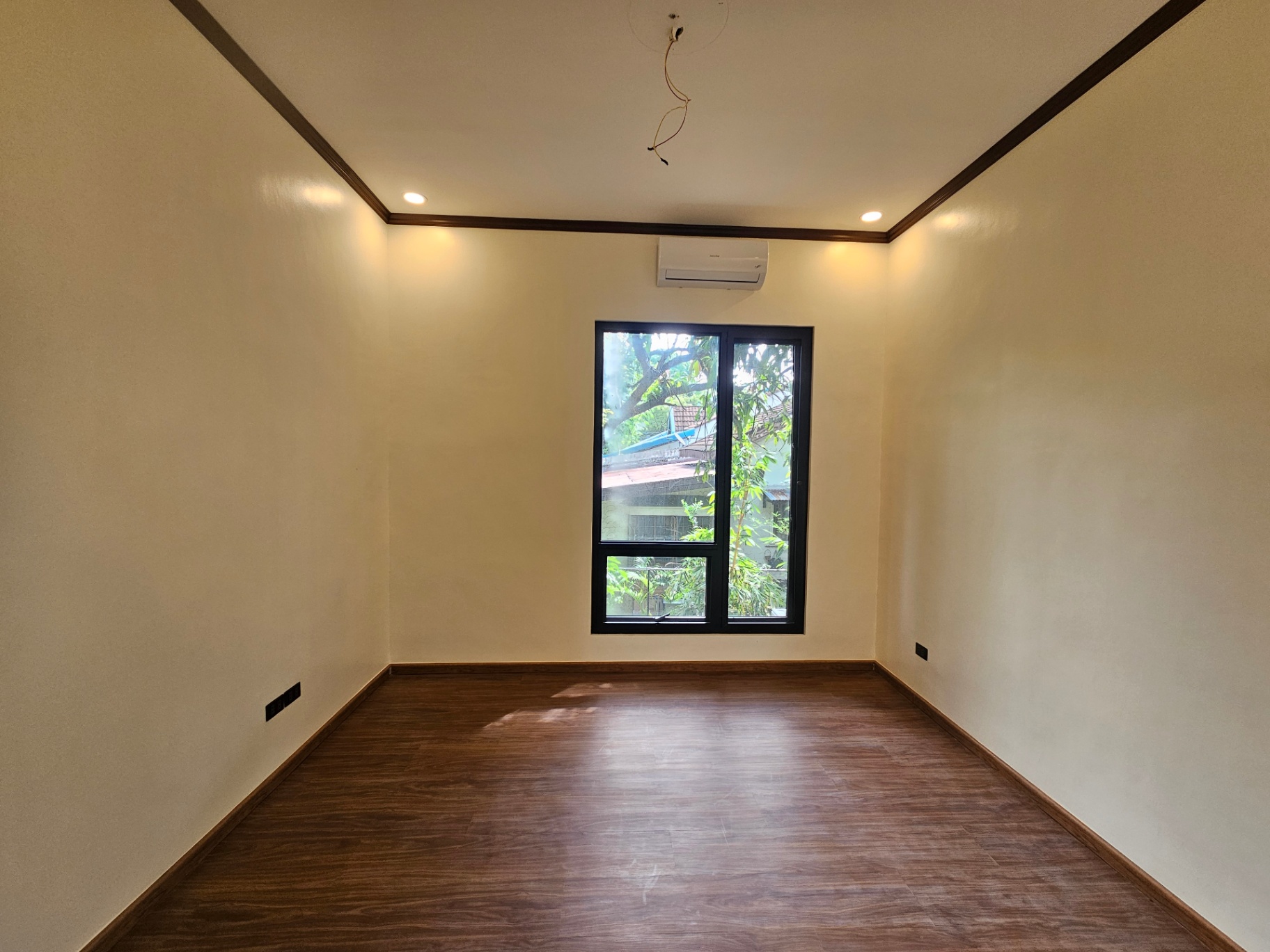 Second bedroom with plank flooring and treetop views
