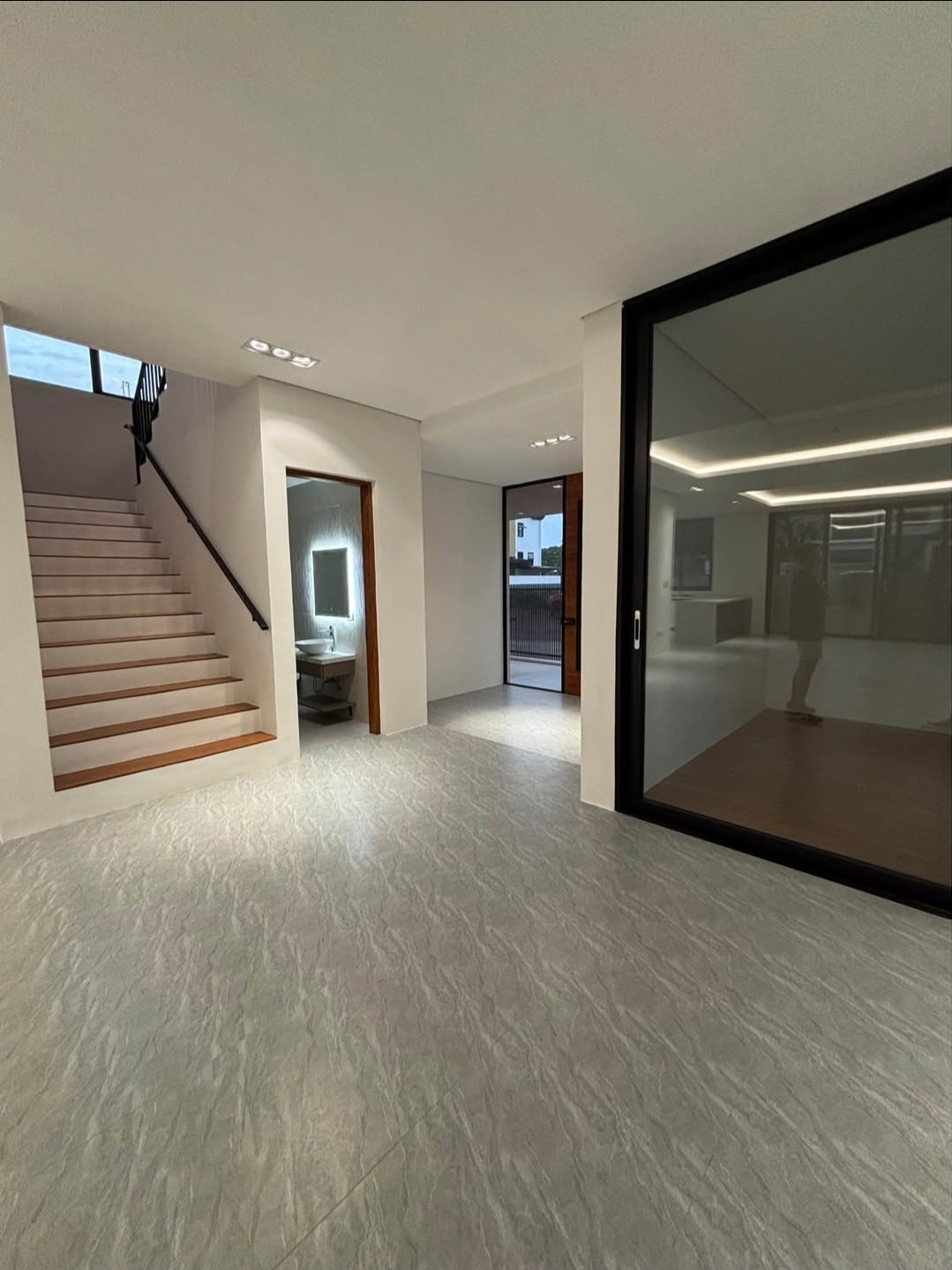 Entrance foyer with timber-treaded stair and powder room