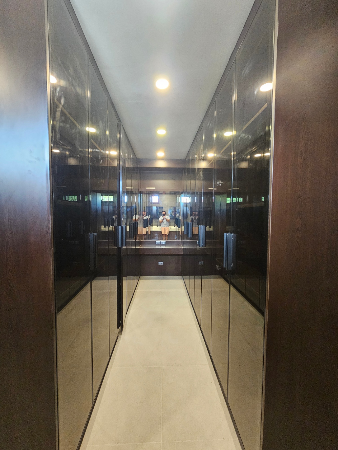 Master walk-in closet with mirrored full-height cabinetry