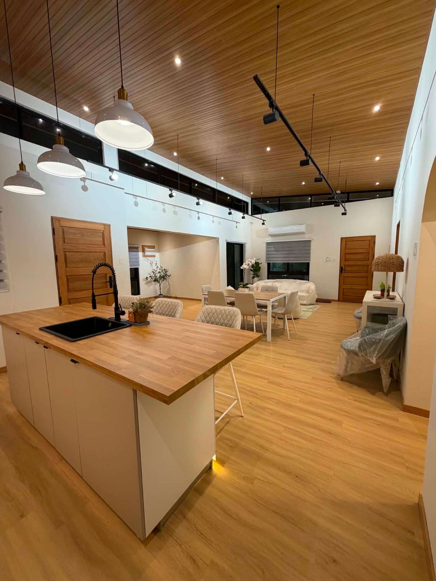 Kitchen island with butcher-block counter looking across to the dining and lounge areas