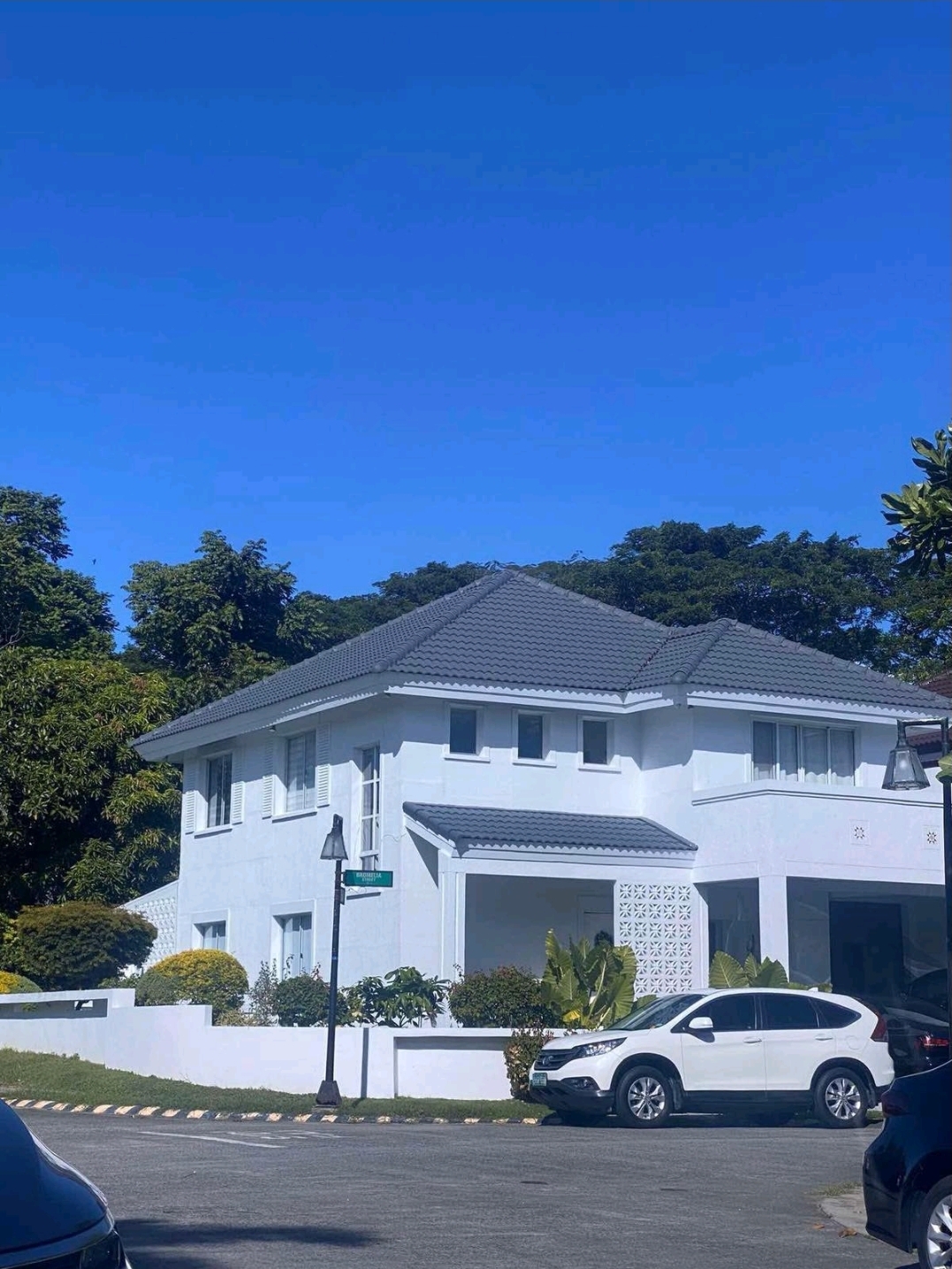 White Mediterranean façade with grey tile roof at Verdana Homes Daang Hari