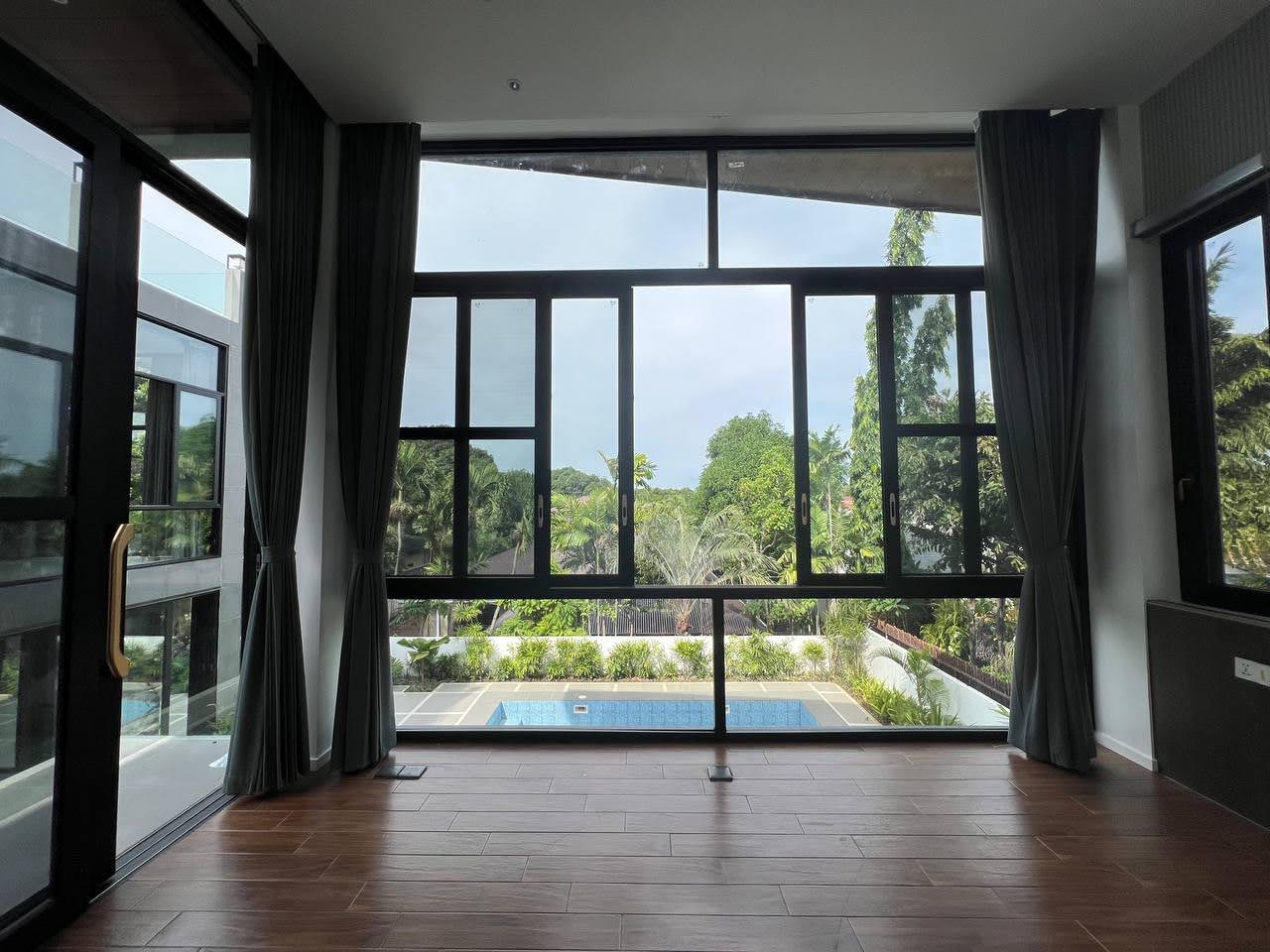 Bright poolside room with wide garden views