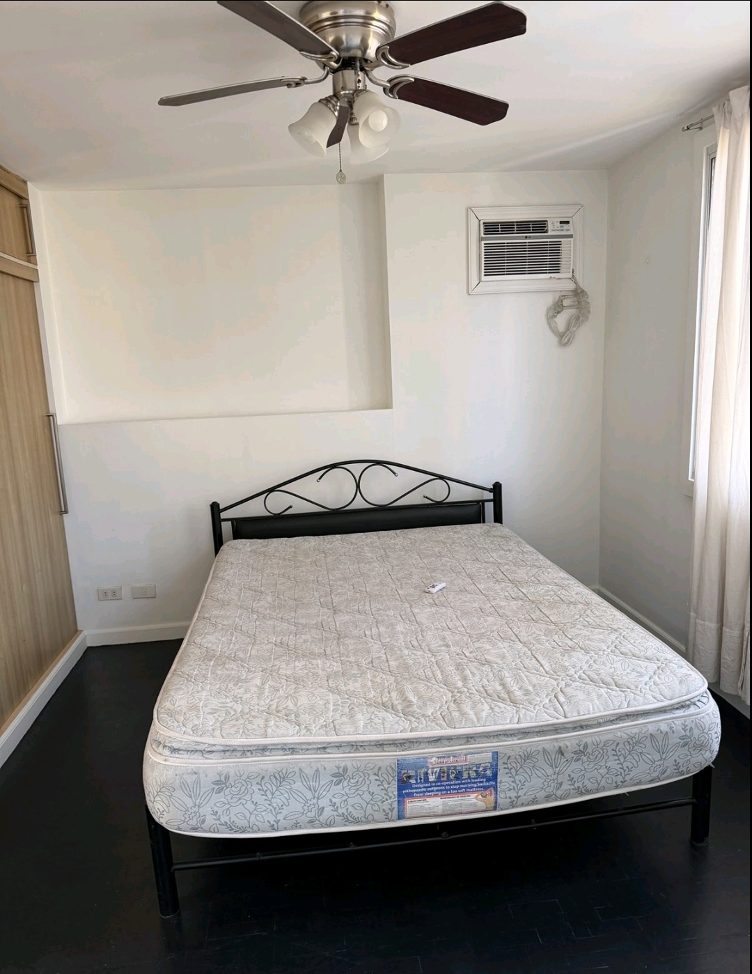 Bedroom with queen bed, air-conditioning, ceiling fan and built-in wood wardrobe