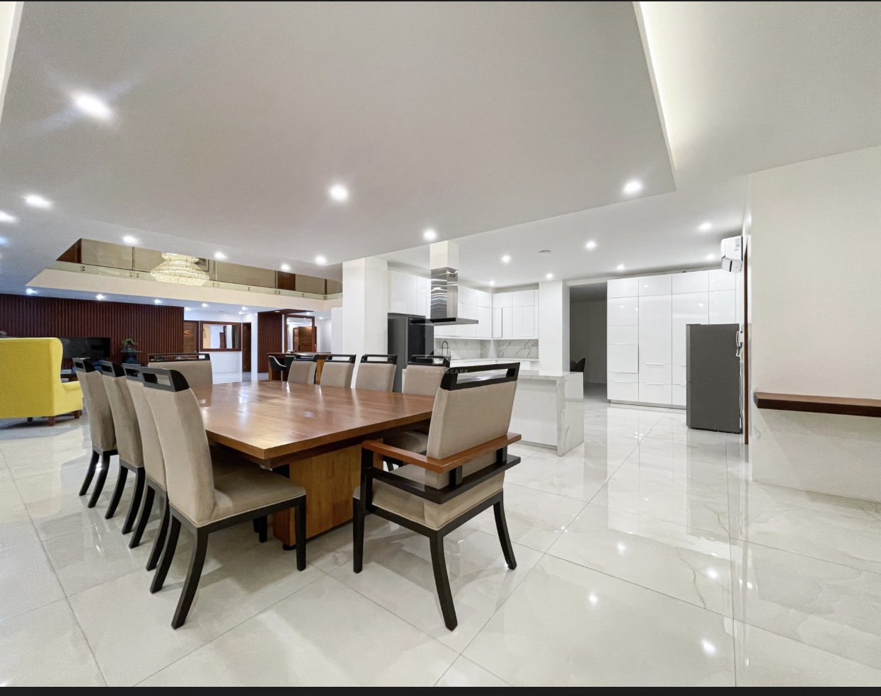 Formal dining room open to a modular white kitchen