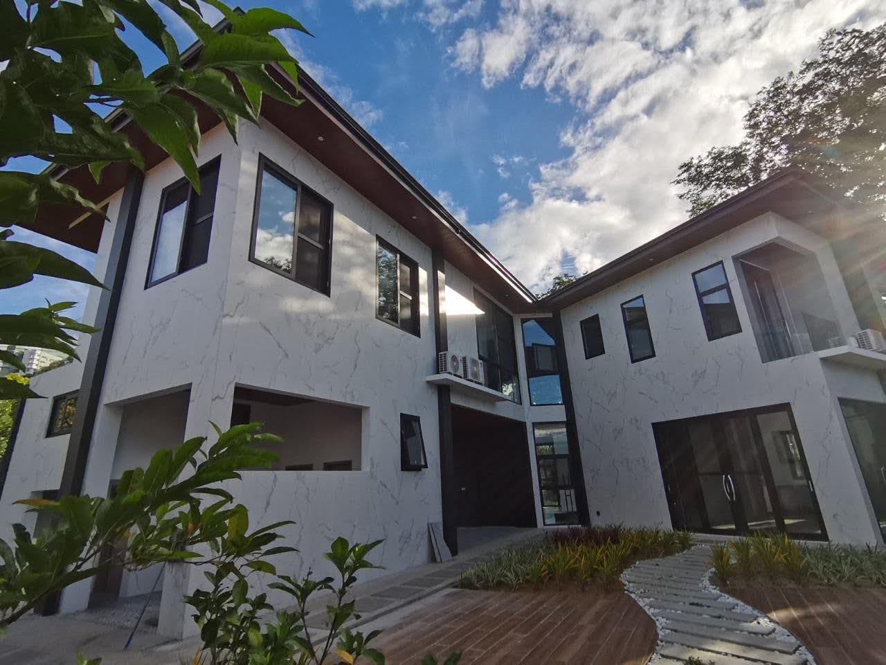 Rear elevation with marble-finished walls and landscaped walkway