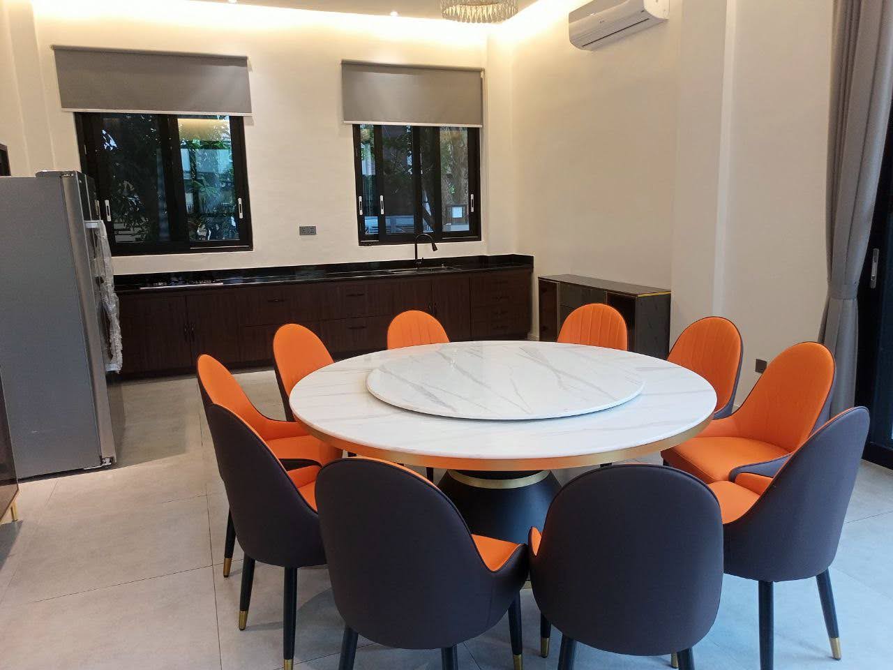 Dining area with round marble lazy-susan table for eight
