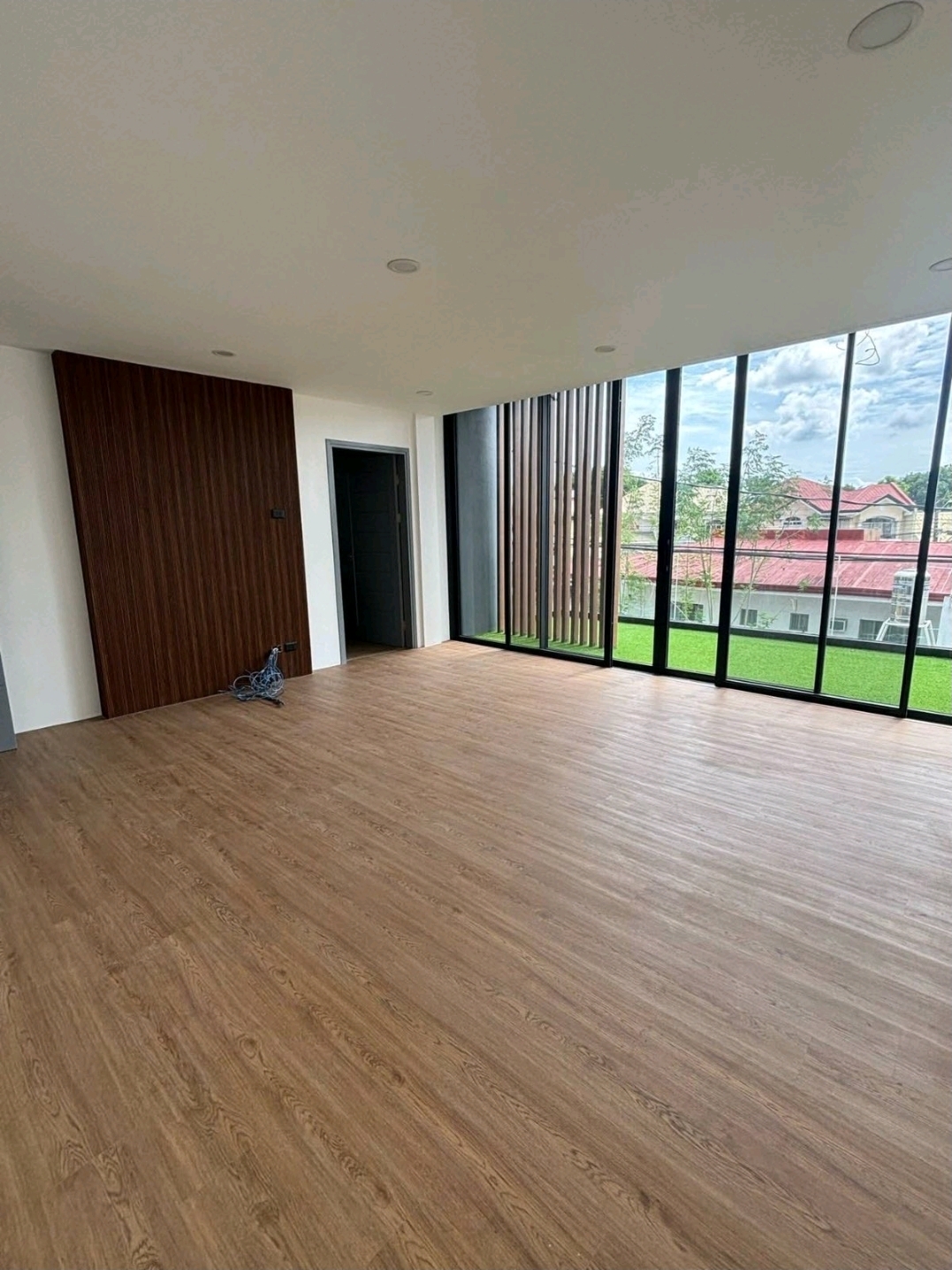 Bedroom with timber feature wall and floor-to-ceiling windows