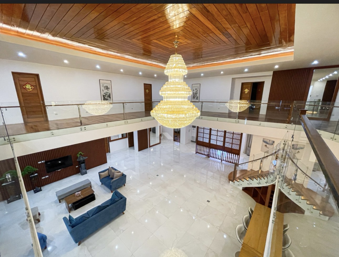 Overhead view of the atrium living area with hardwood ceiling and chandelier