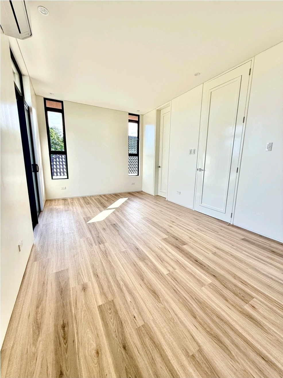 Bedroom with slim clerestory windows and closet doors