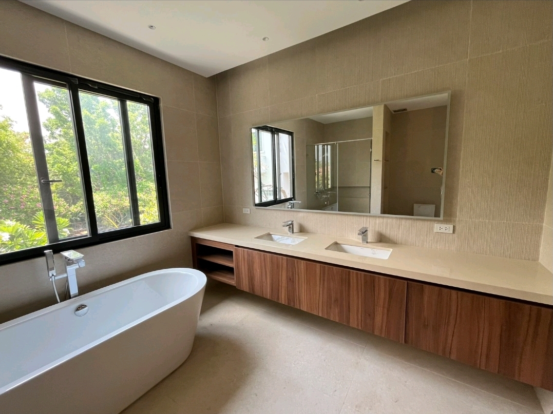 Master bathroom with freestanding tub, double vanity and garden window