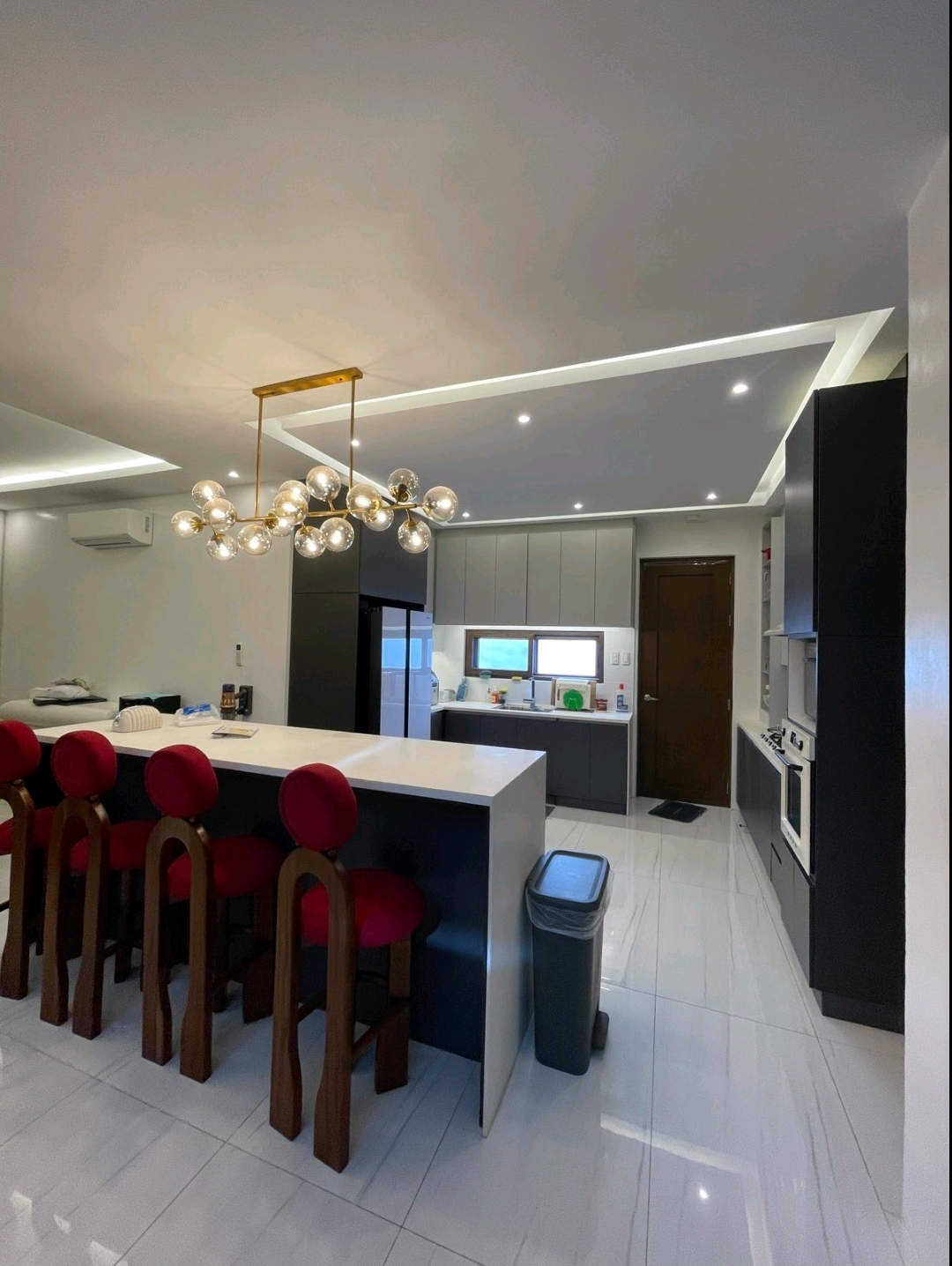 Breakfast counter with bar stools and service kitchen