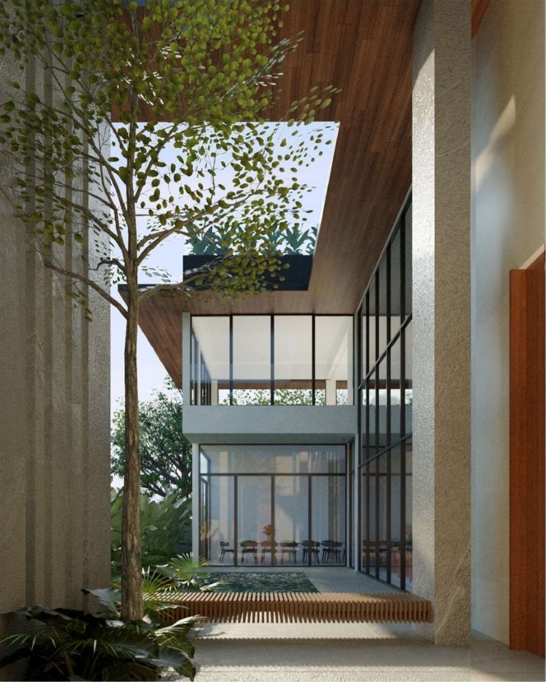 Double-height planted atrium with full-height glazing onto the dining area