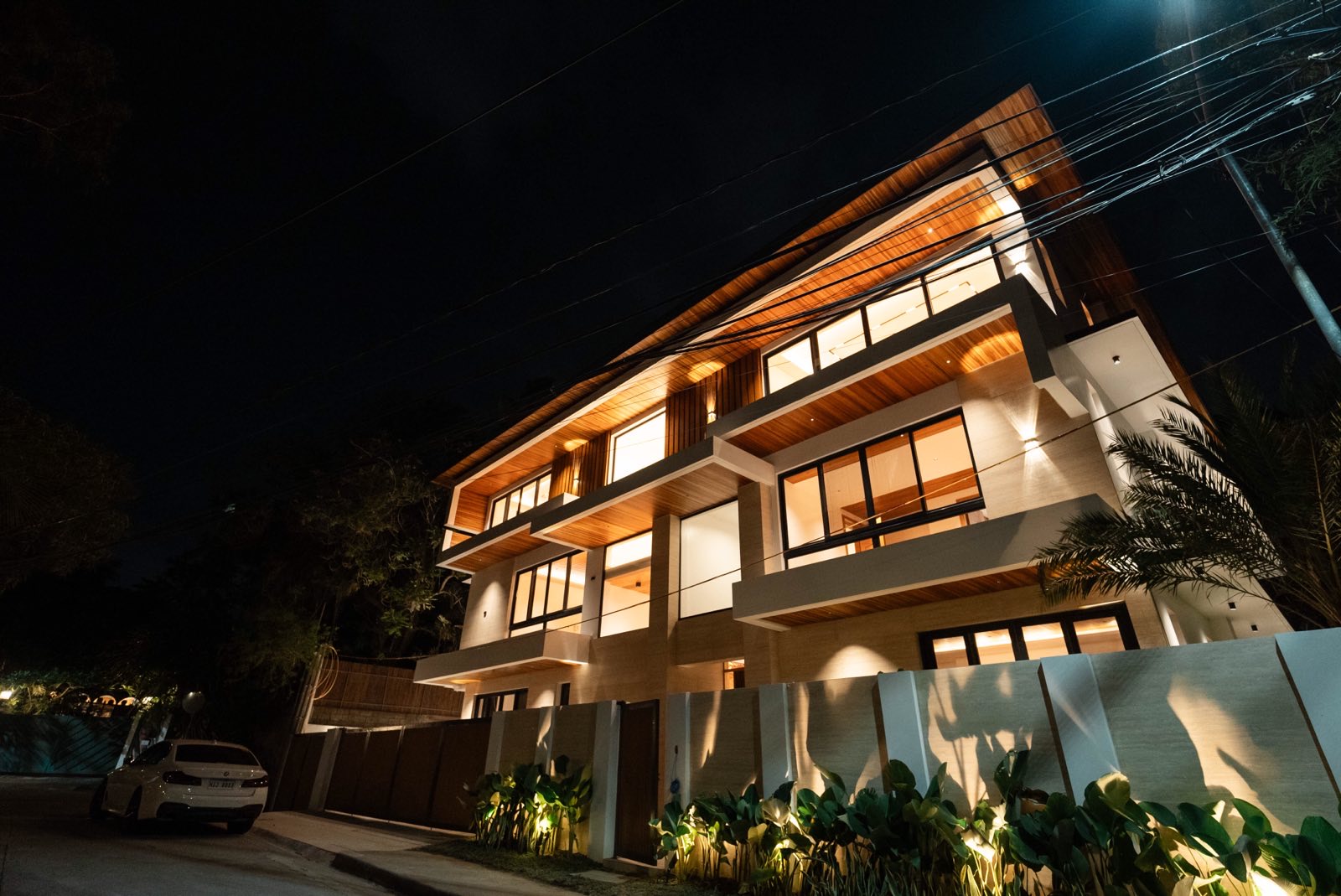 The Ayala Alabang Travertine Mansion — contemporary facade lit at night