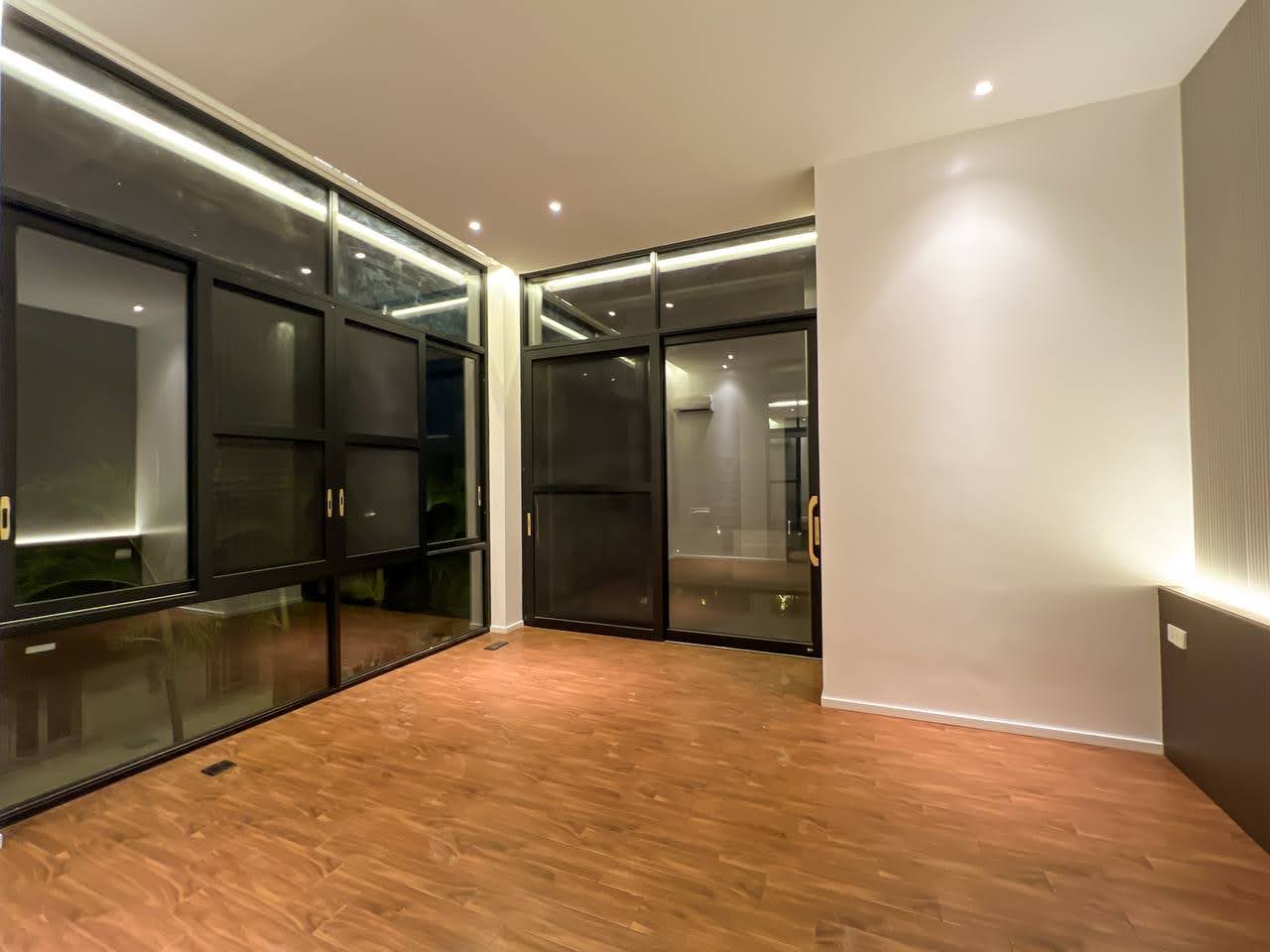 Study room framed by black-framed picture windows