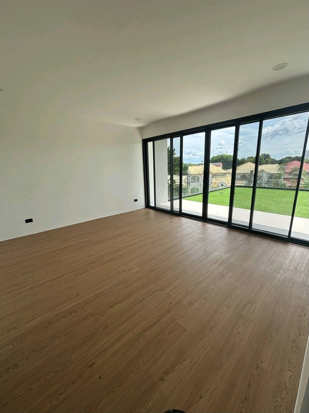 Bedroom with wide sliding glass doors overlooking the garden