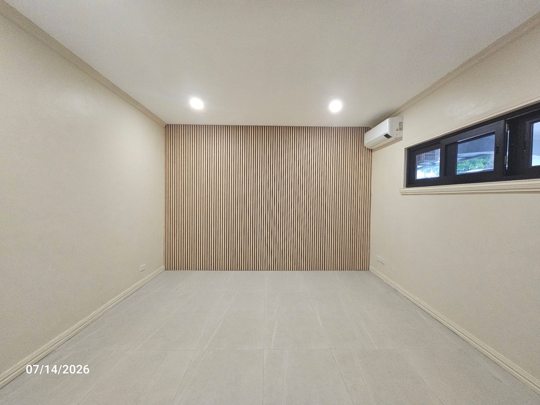 Bedroom or den with light oak vertical slat feature wall and clerestory windows
