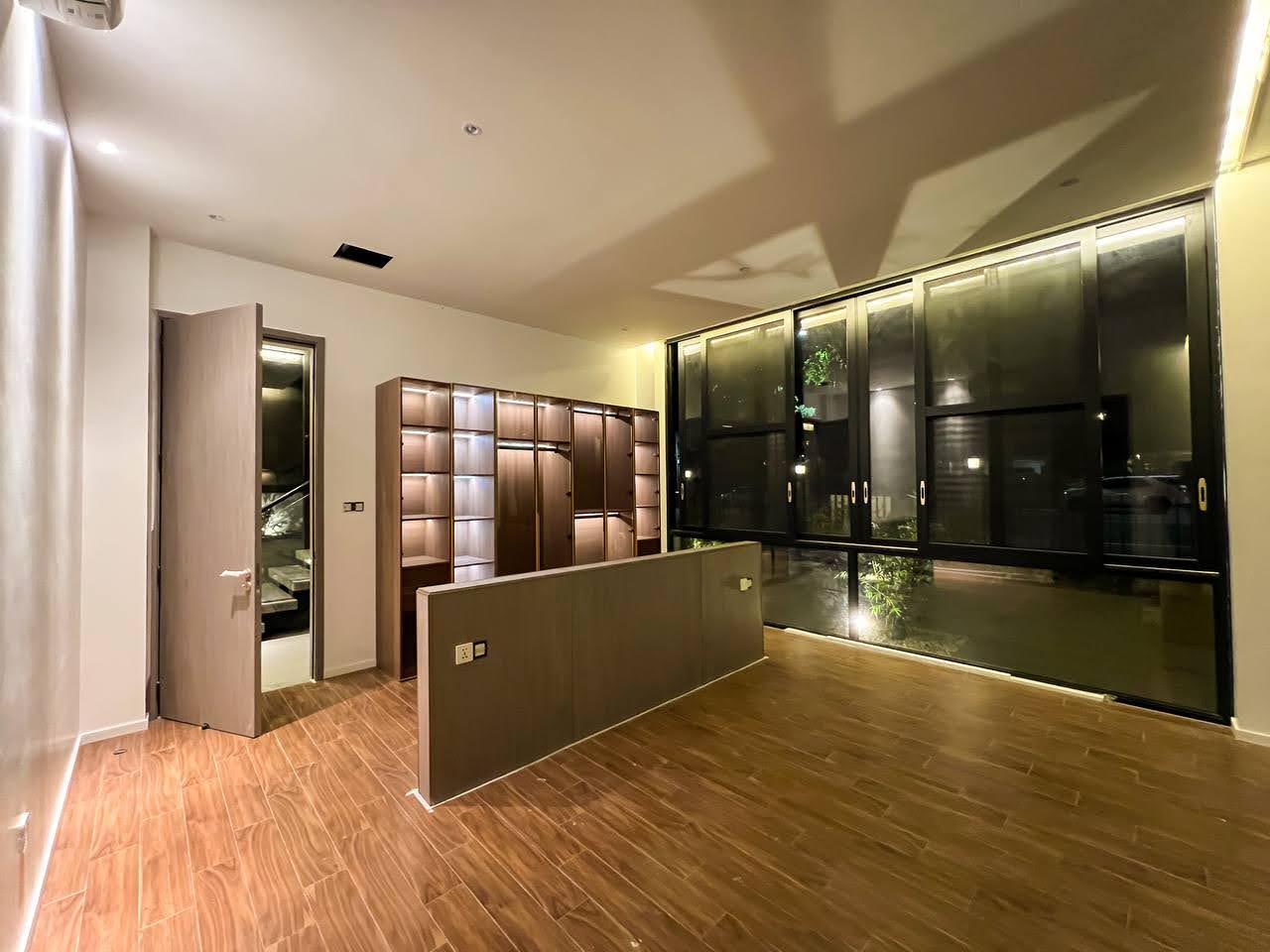 Bedroom with built-in wardrobes and wood-look flooring
