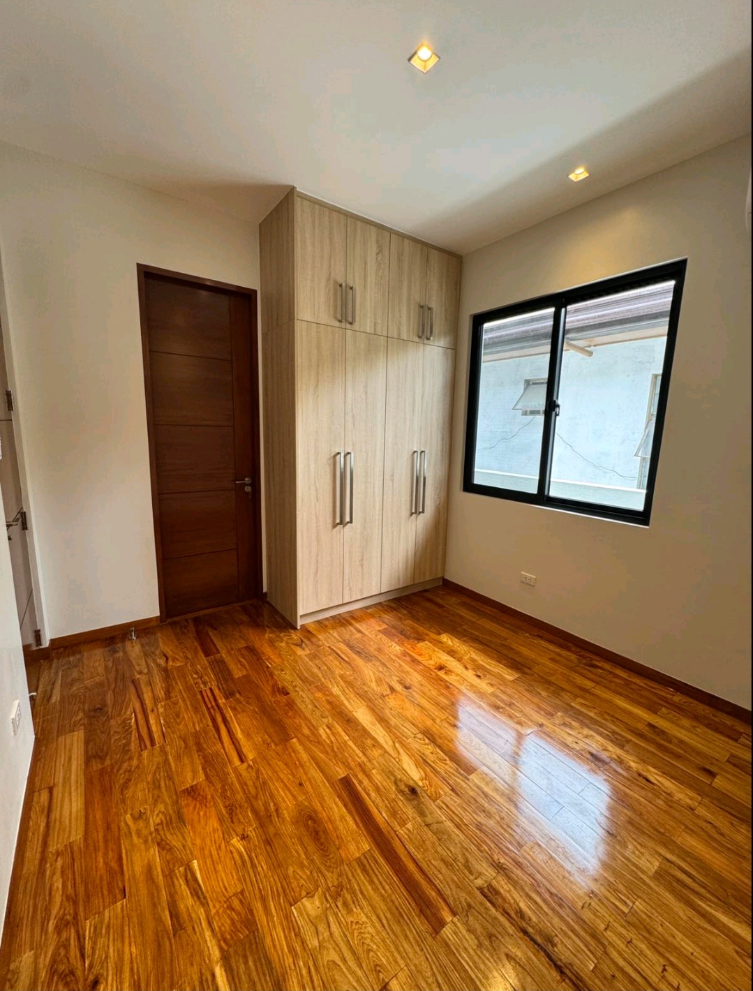 Bedroom with narra flooring and full-height built-in wardrobe
