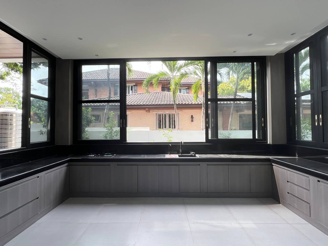 Modern kitchen with dark stone counters and garden window