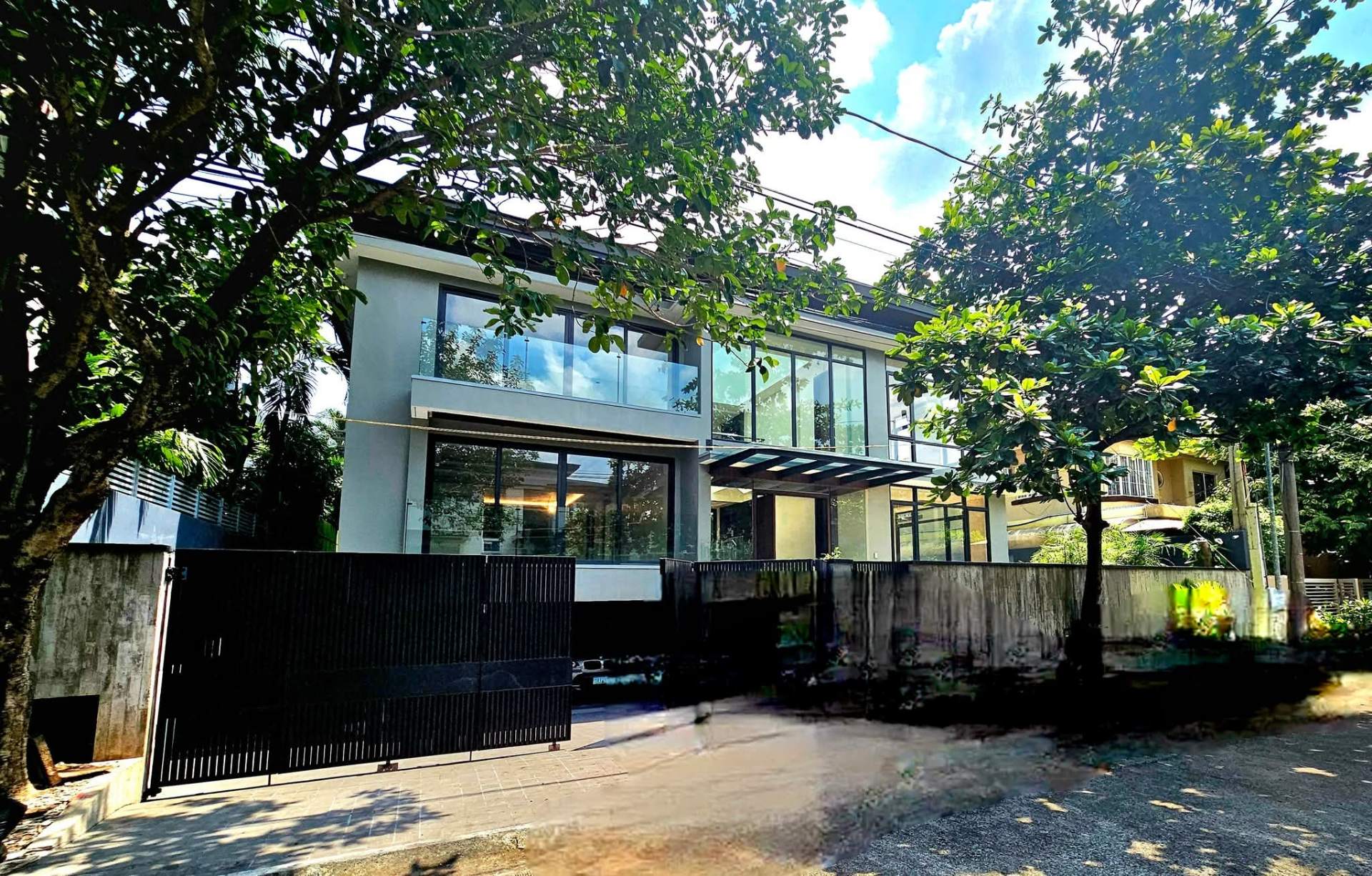 Brand-new modern glass-walled home facade in Ayala Alabang Village
