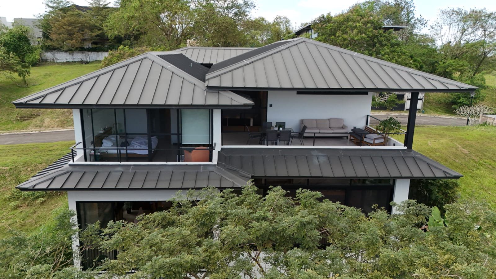 Aerial of single-loaded modern tropical home in Ayala Westgrove Heights